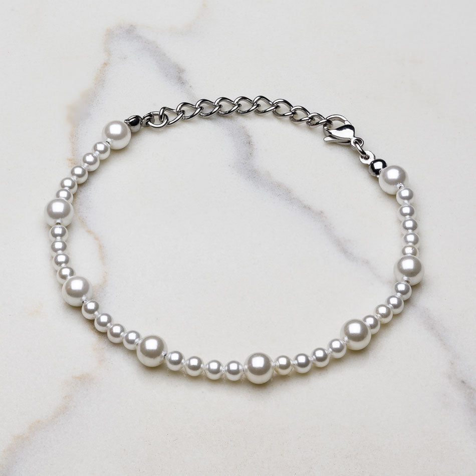 Our Asymmetric Pearl Bracelet has been crafted using different sized polished white pearls, along with the finest silver hardware to hold it all together.