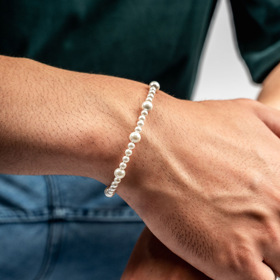 Our Asymmetric Pearl Bracelet has been crafted using different sized polished white pearls, along with the finest silver hardware to hold it all together.