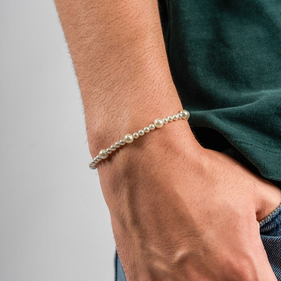 Our Asymmetric Pearl Bracelet has been crafted using different sized polished white pearls, along with the finest silver hardware to hold it all together.