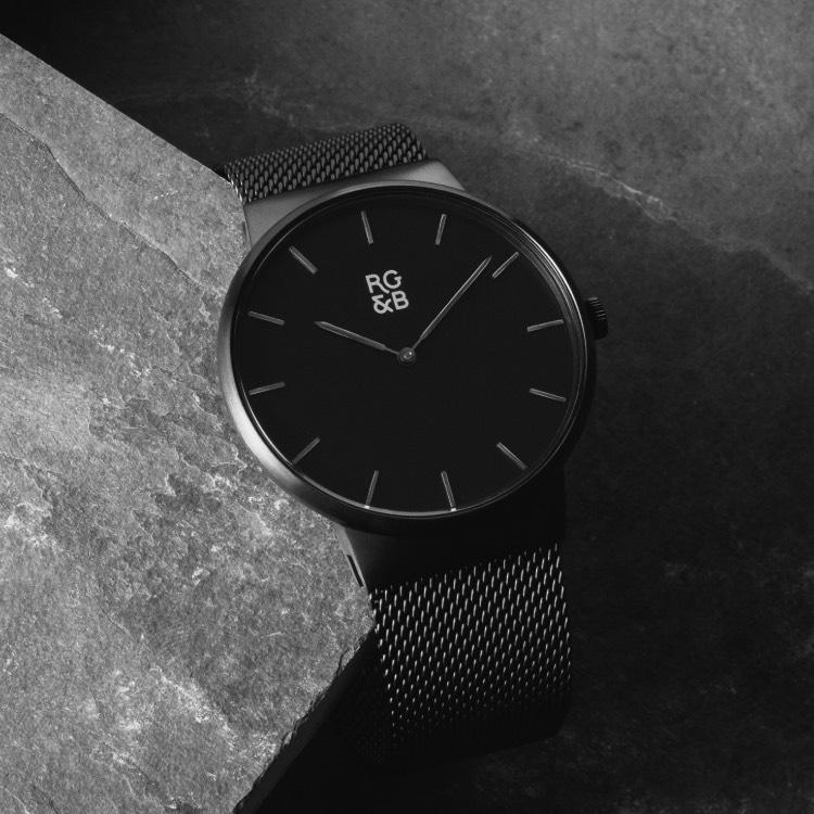 Minimal Black Watch - Our Minimal Black Watch Features a Brushed Black Stainless Steel Case and Strap, Gunmetal Hands and Hour Markers Along with our Signature Logo.