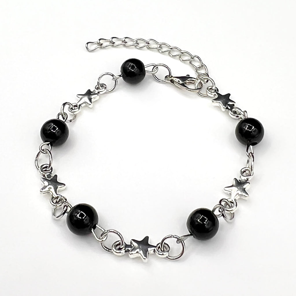 Our Astralis Chain & Bead Bracelet features black onyx beads and a silver star chain design, resulting in a bold silver & black bracelet for men.