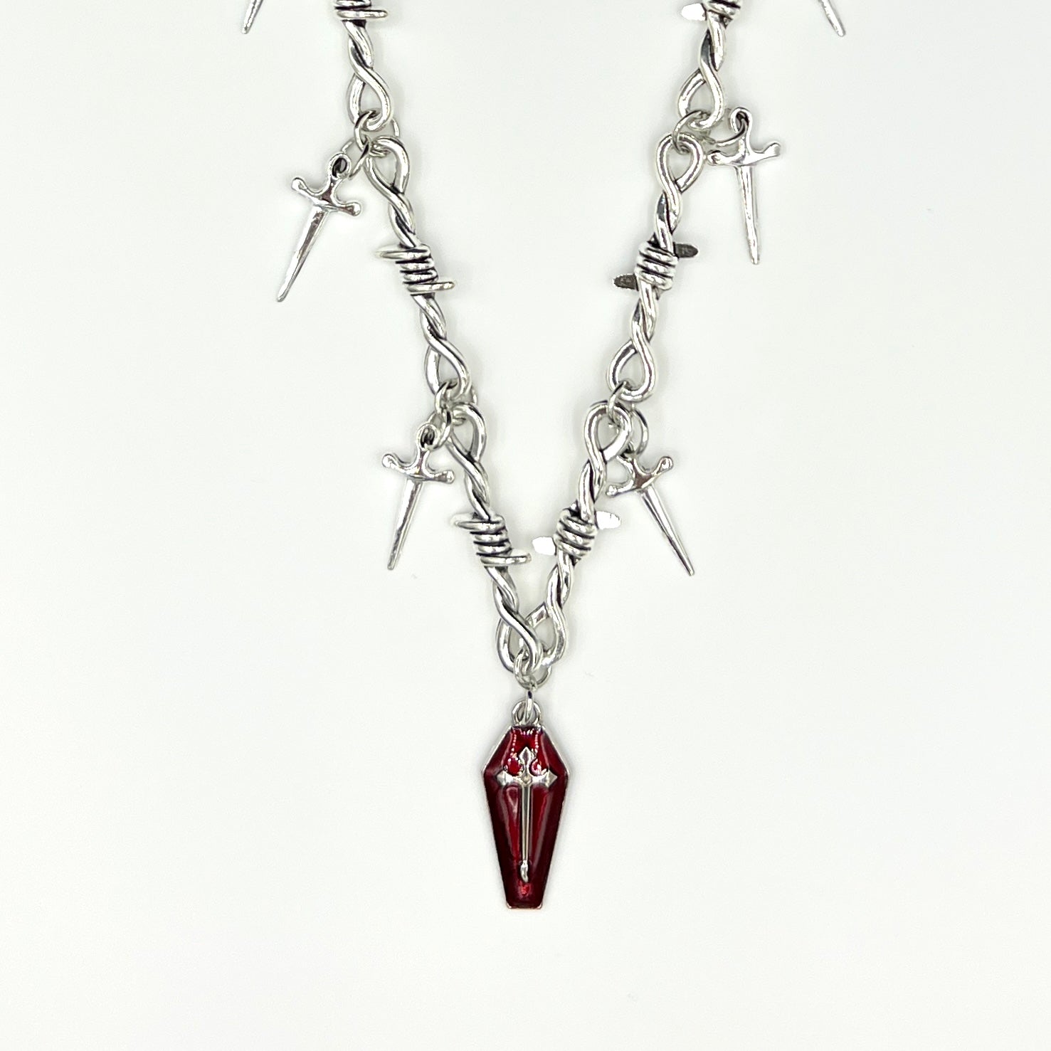 Our Crimson Dagger Pendant Necklace has been hand crafted using our silver barbed wire link chain and our crimson dagger pendant.