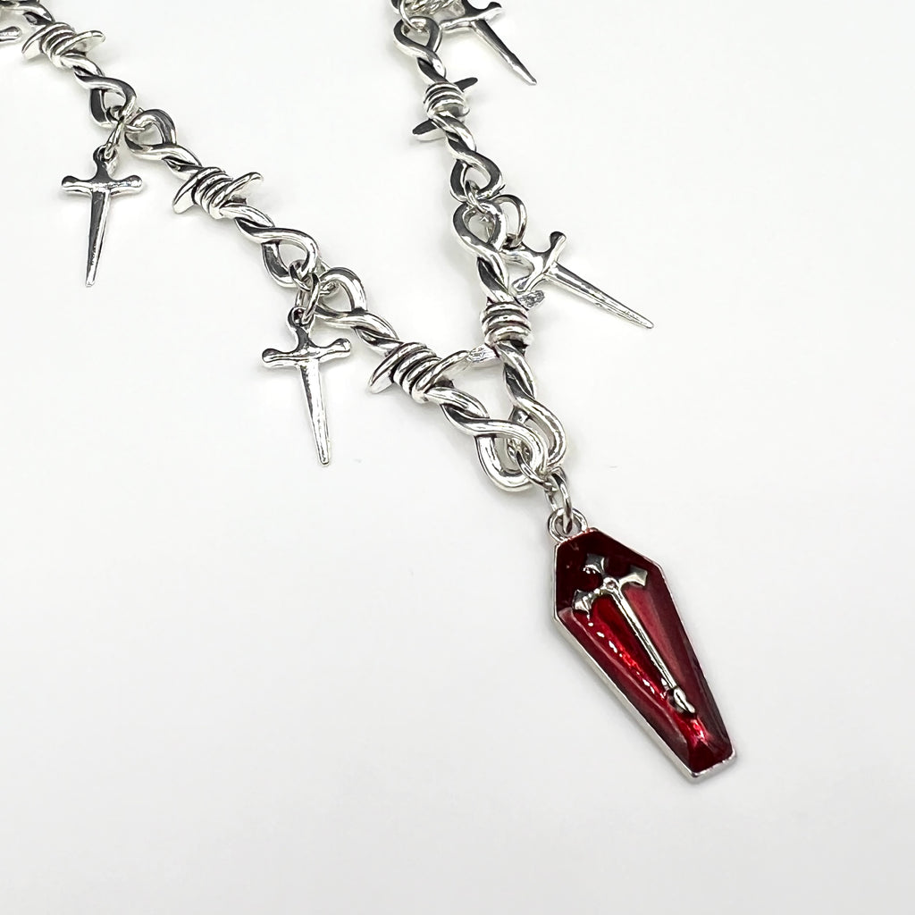 Our Crimson Dagger Pendant Necklace has been hand crafted using our silver barbed wire link chain and our crimson dagger pendant.