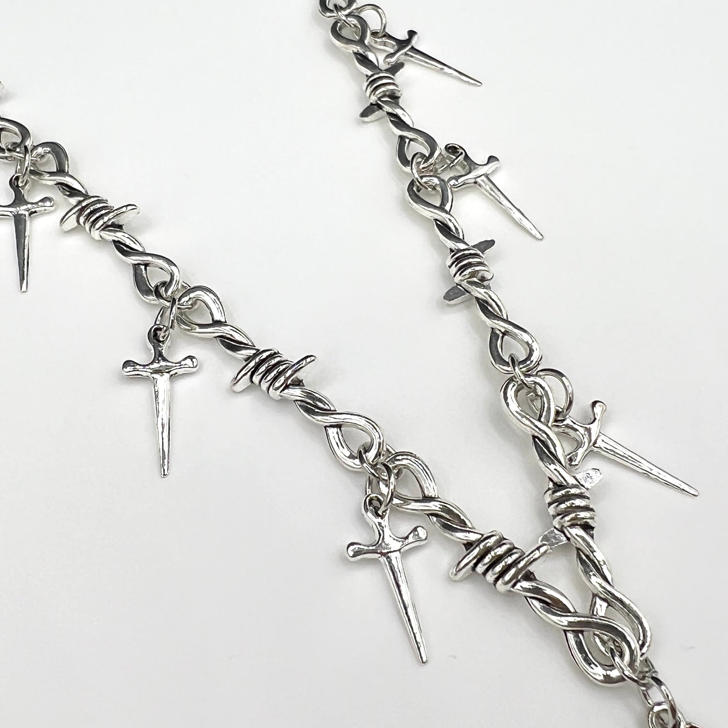 Our Crimson Dagger Pendant Necklace has been hand crafted using our silver barbed wire link chain and our crimson dagger pendant.