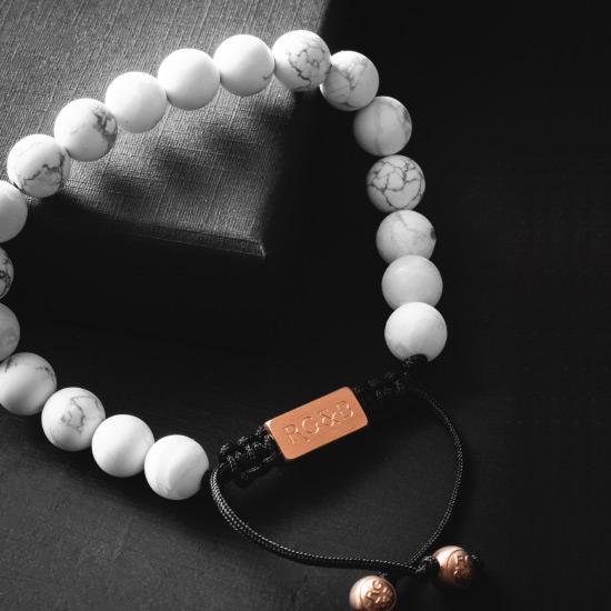 Howlite Bead Bracelet - Our Howlite Bead Bracelet Features Natural Stones, Waxed Cord and Brushed Rose Gold Steel Hardware. A Beautiful Addition to any Collection.