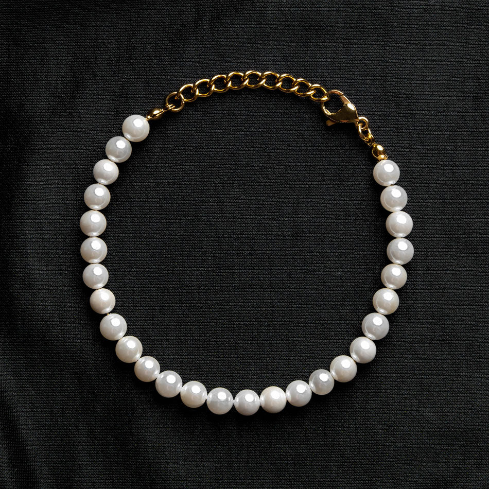 Our Pearl Bracelet with 24KT Gold Plated Hardware has been crafted using polished white pearls, along with the finest gold chain to hold it all together.