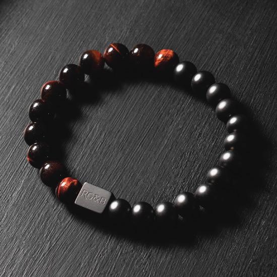 Red Tiger Eye Bead Bracelet - Our Red Tiger Eye Bead Bracelet Features 8mm Natural Stones, Premium Elastic Cord and Brushed Black Hardware. A Beautiful Addition to any Collection.