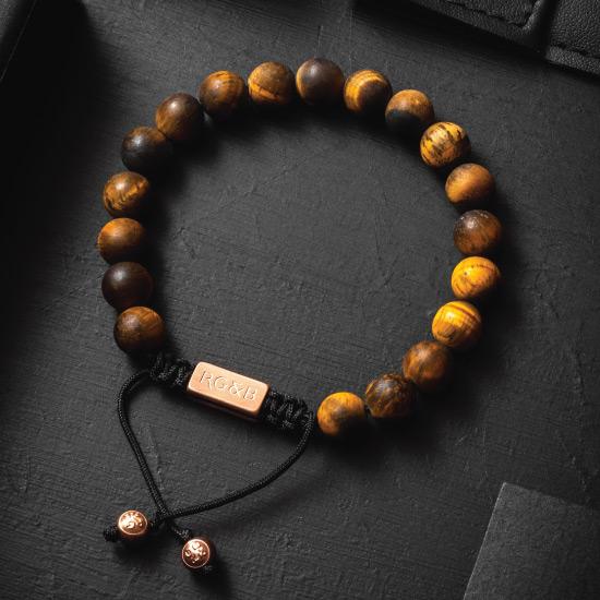 Tiger's Eye Bead Bracelet - Our Tiger’s Eye Bead Bracelet Features Natural Stones, Waxed Cord and Brushed Rose Gold Steel Hardware. A Beautiful Addition to any Collection.