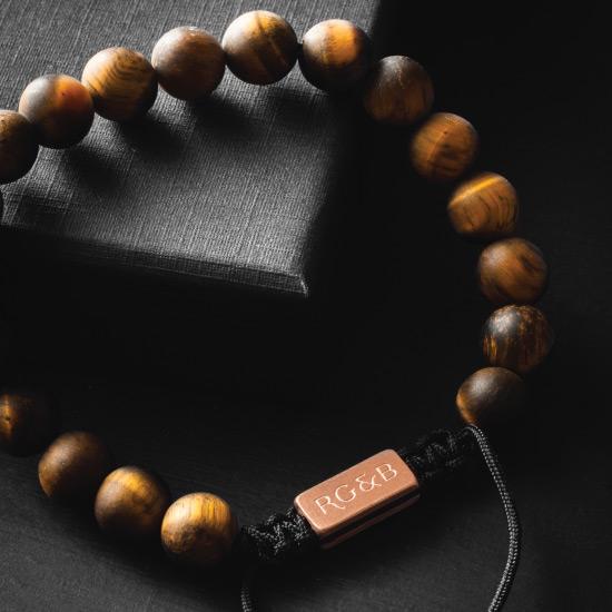 Tiger's Eye Bead Bracelet - Our Tiger’s Eye Bead Bracelet Features Natural Stones, Waxed Cord and Brushed Rose Gold Steel Hardware. A Beautiful Addition to any Collection.